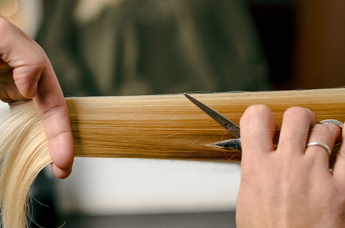 image of sleek hair being cut with scissors